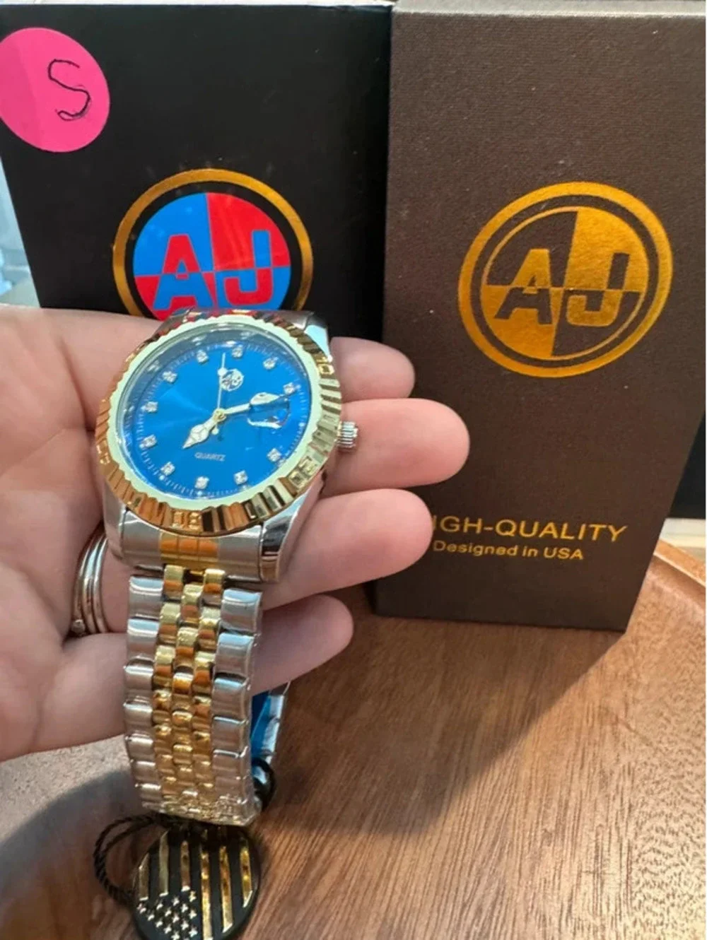 AJ watch, blue face, gold and silver toned band
